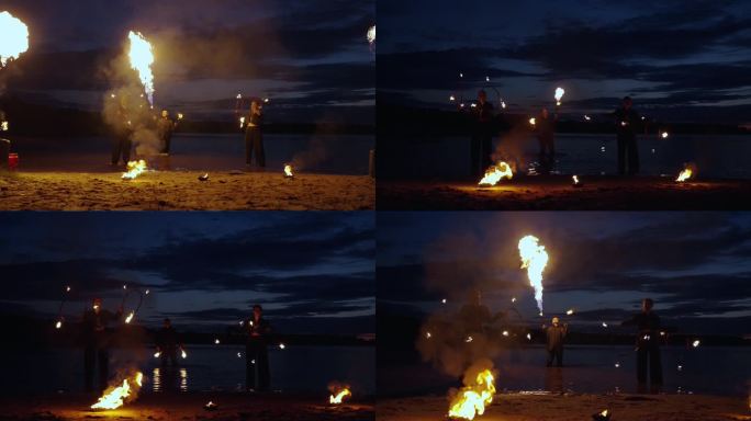 夜河滩上的神秘火表演，人们在黑暗中旋转燃烧的火把