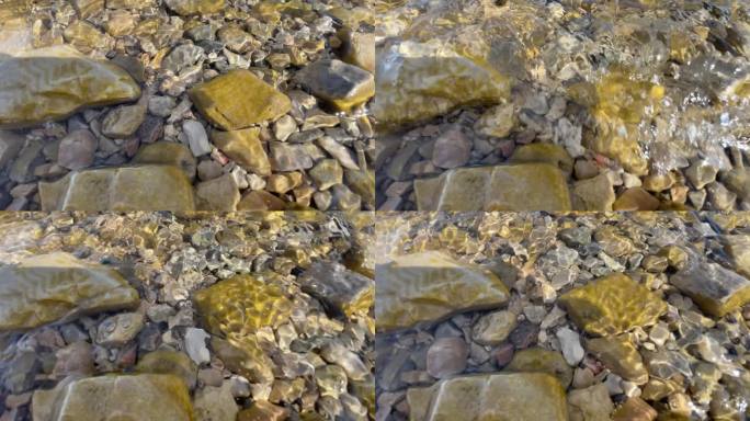 湖水浪花打在石头上波光粼粼