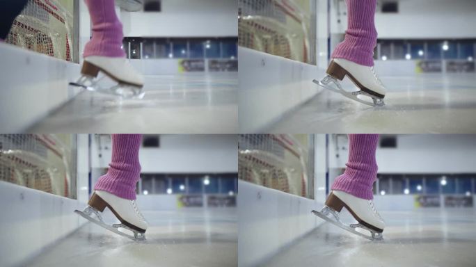 花样滑冰运动员在冰上滑脚进入冰场开始她的训练穿着粉红色的护腿近距离拍摄