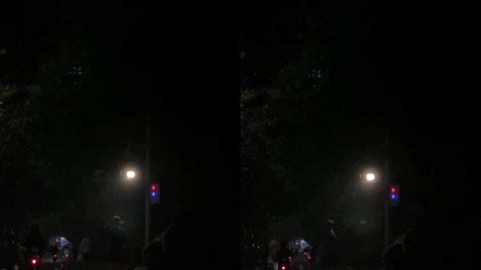 夜晚凌晨路灯下的行人骑电动车夜间路人