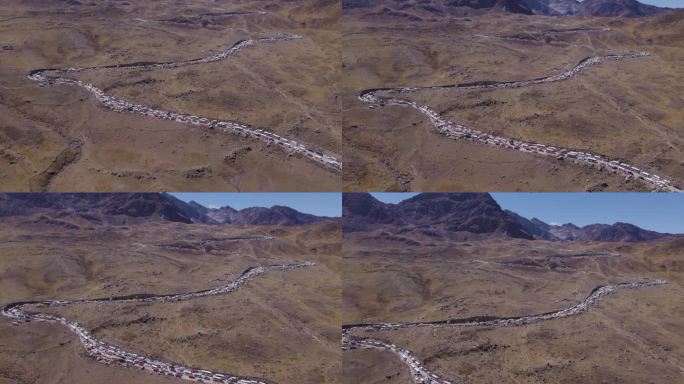 电影无人机捕捉到万卡约(秘鲁)早晨，市民们聚集在华塔帕拉纳山上参加塔塔香提节。这条路是个交通奇观。鸟