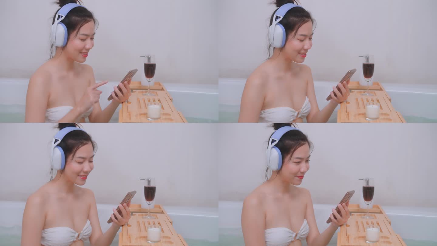 亚洲女人沉浸在浴缸的旋律中。