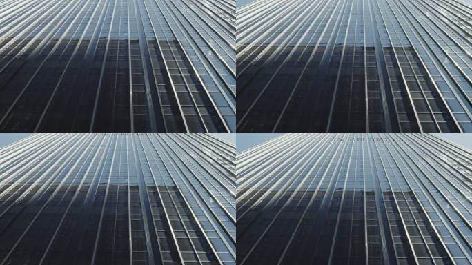纽约玻璃现代摩天大楼反光表面的低角度抽象镜头。受欢迎的美国旅游和商务目的地。银行、商业和企业概念