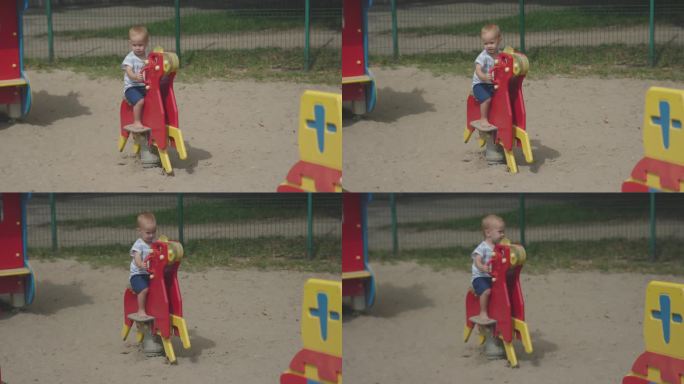 小孩子赤脚骑着旋转木马在彩色儿童游乐场里摇摆