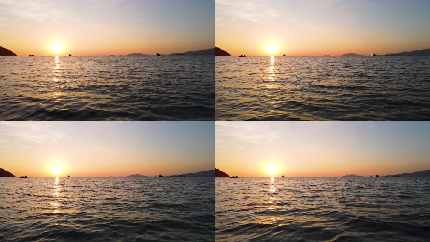 在日落背景下低水位飞越海洋，泰国沙卡通里比岛