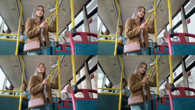 一名女子站在公交车上，拿着手机和交通工具在城市通勤，开车时使用移动应用程序。公共旅行，服务或乘车，女