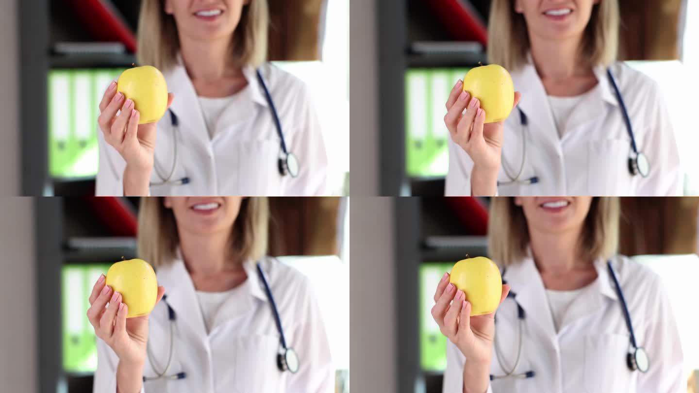 医生营养学家治疗师拿着黄苹果