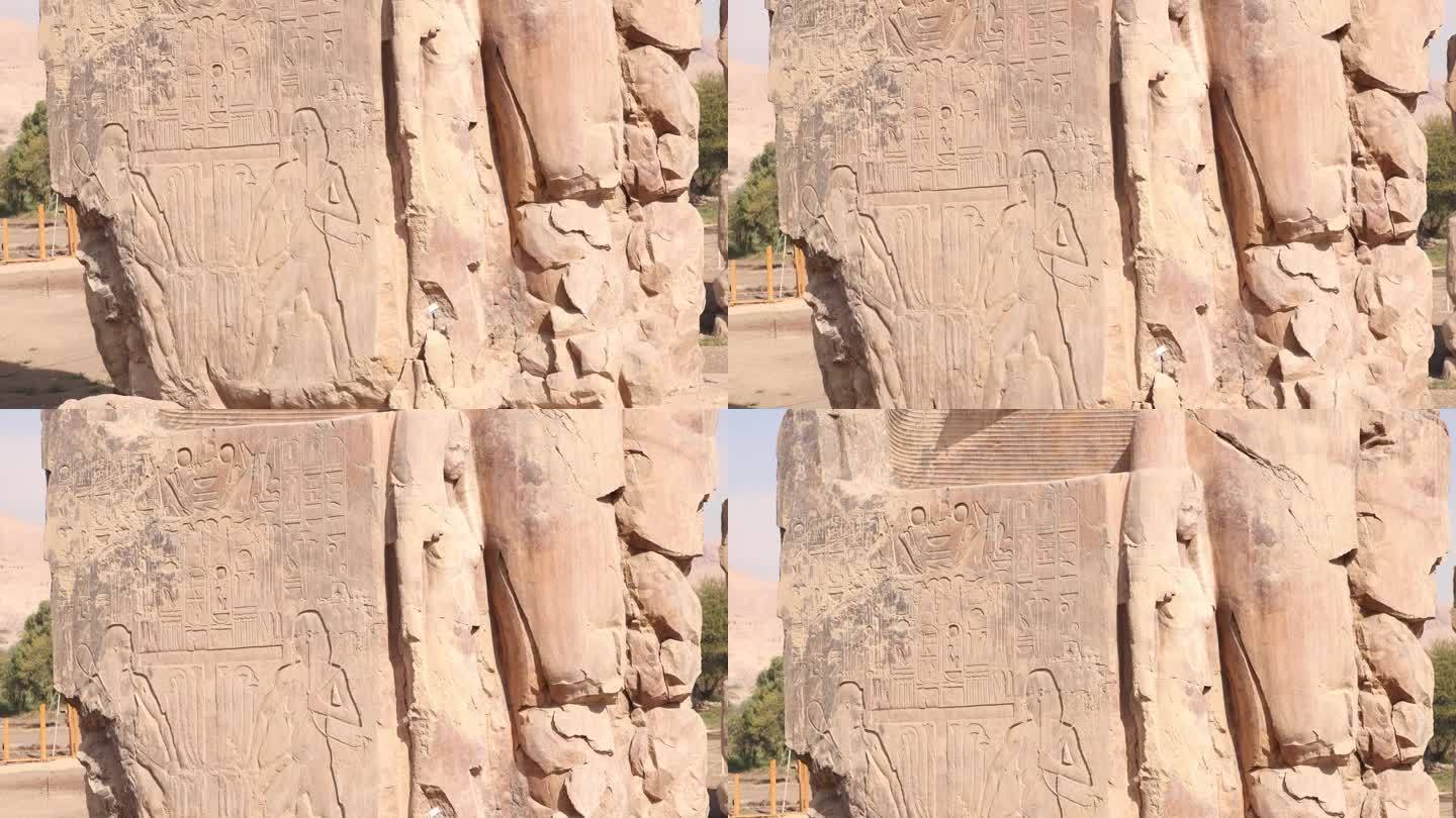 在埃及卢克索的门农巨像中，以山脉为背景的法老巨大雕像的废墟