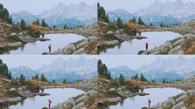 徒步旅行期间，一名女子站在奥地利的湖泊背景上