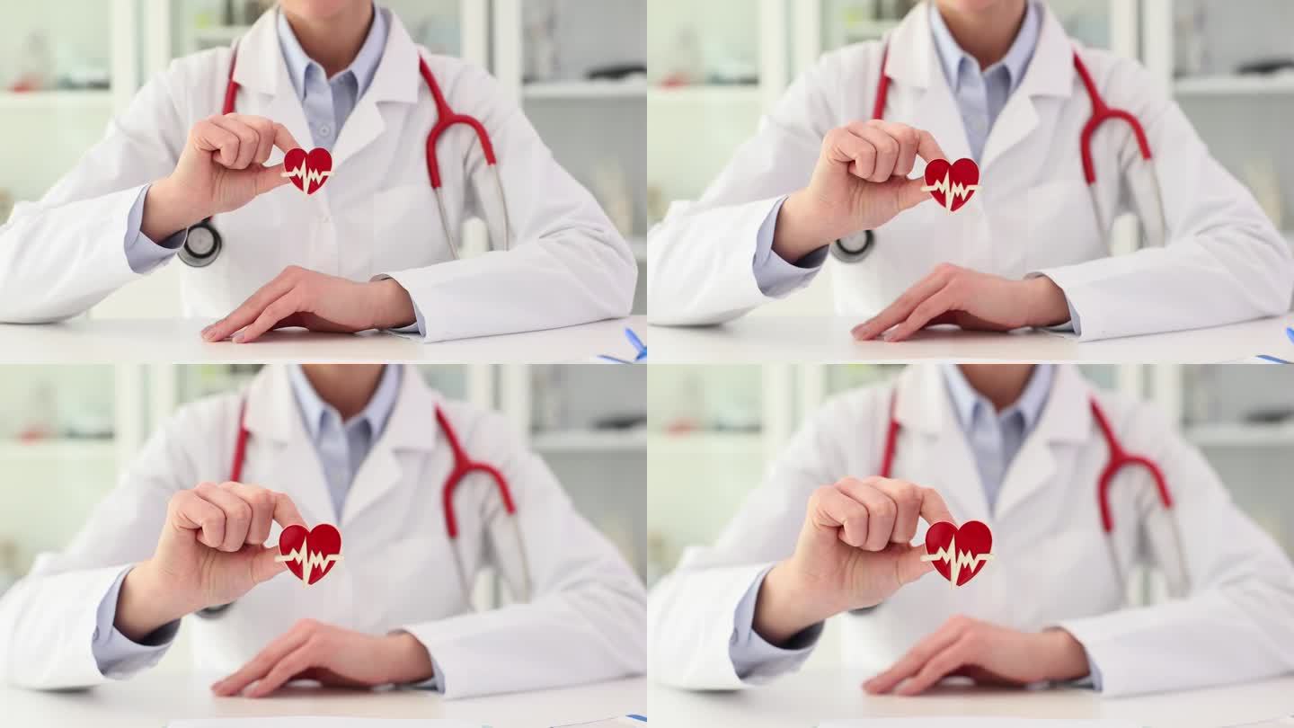 心脏病专家医生手里拿着红色的心脏图标特写