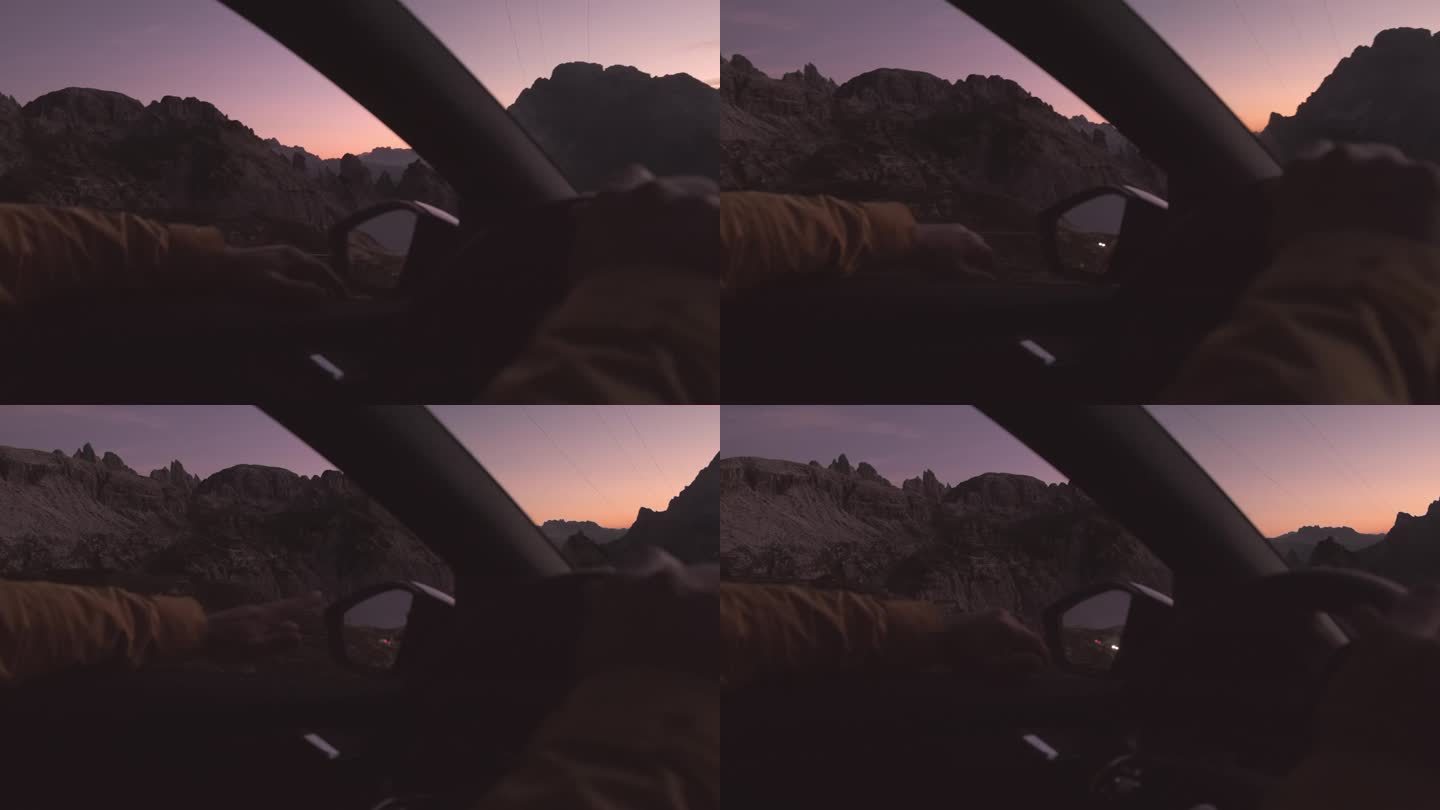 在阿尔卑斯山脉，一名男子开车时把手伸出窗外