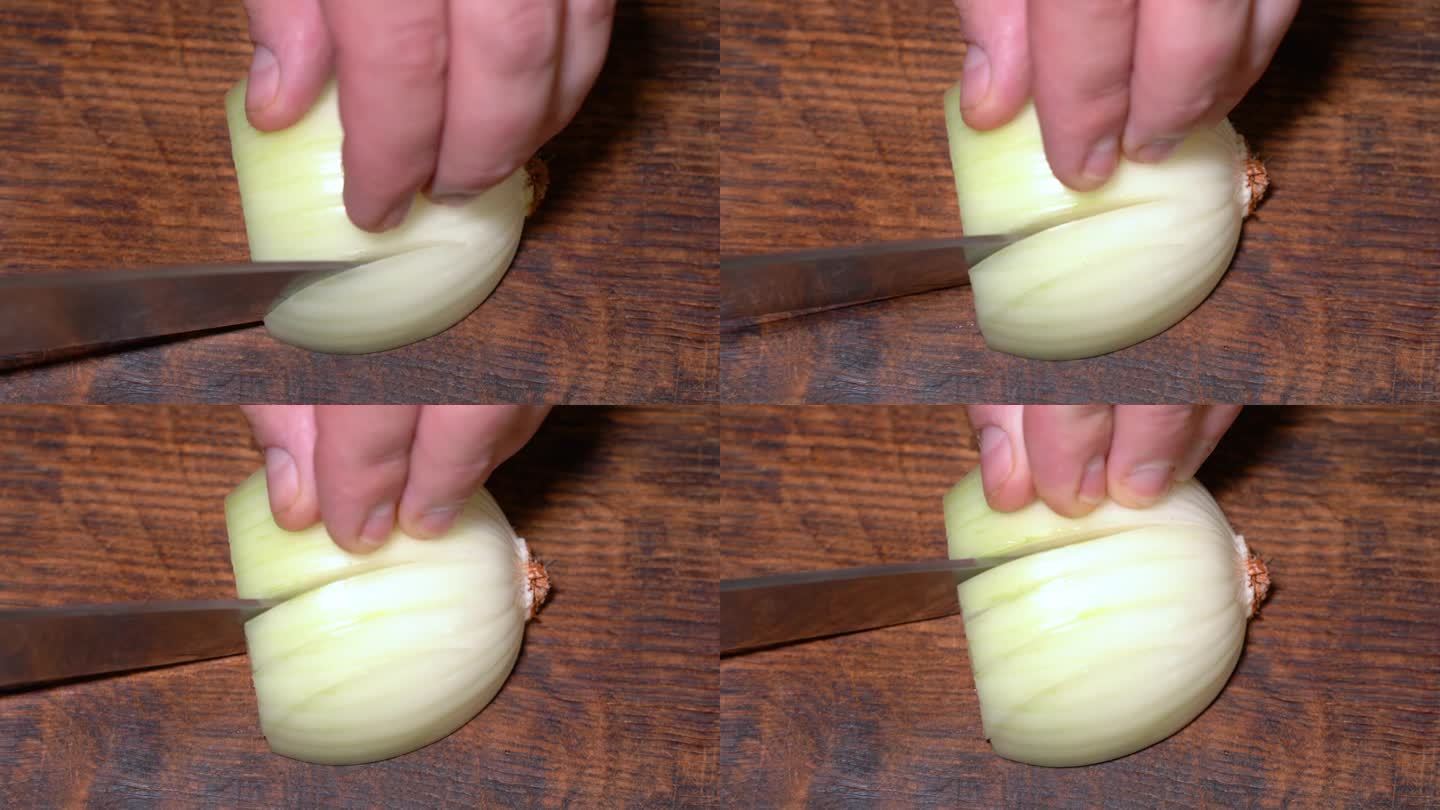 厨师在切菜板上切洋葱。高品质4k画面
