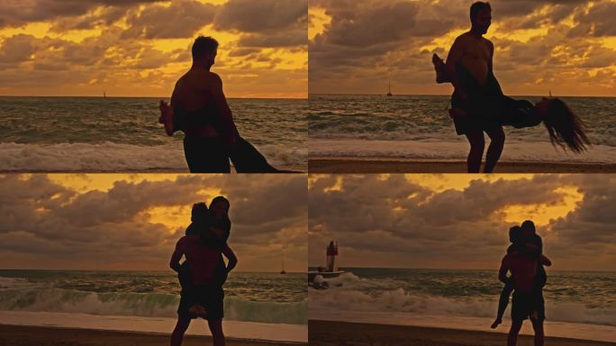 快乐的冲浪夫妇拥抱和旋转在日落的海滩上