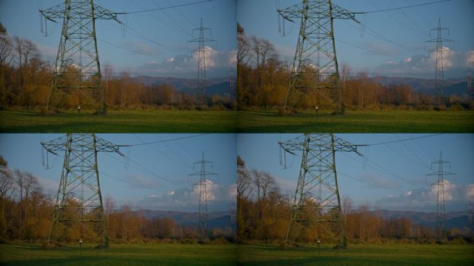 蓝天下电站草地上的SLO MO电塔。采购产品电力线，电力电缆，电力，燃料和发电