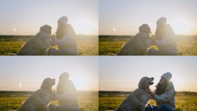 一个女人在草地上和一只金毛猎犬玩耍。抚摸狗