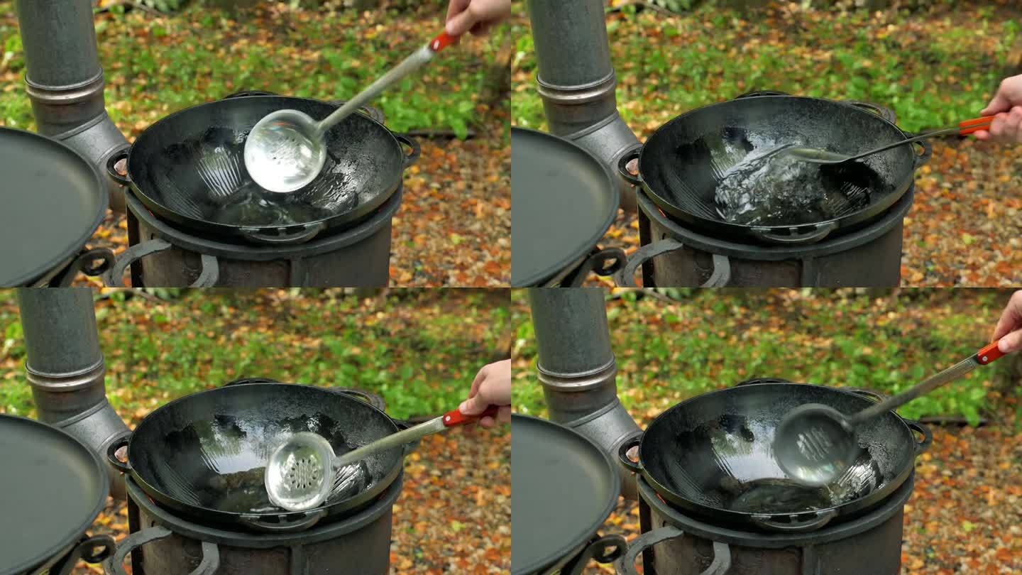 厨房用热铸铁油锅润滑。4k视频片段