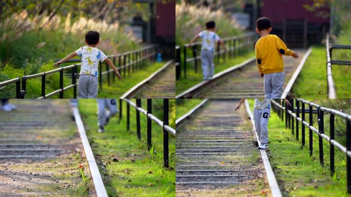 亲子儿童小孩在火车轨道上平衡行走生活美好