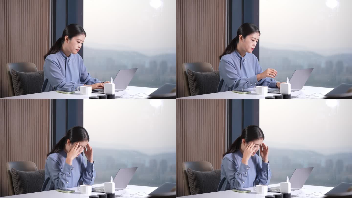 职业女性在办公室笔记本电脑看手机