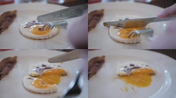 用刀叉切蛋黄吃白盘子里的煎蛋。切单面鸡蛋，蛋黄溏心