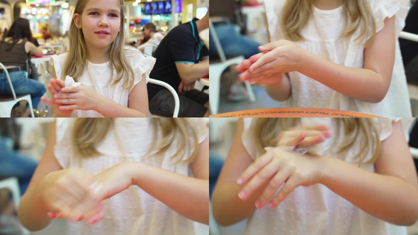 一个十几岁的女孩在咖啡馆吃完东西后用湿布擦了手。