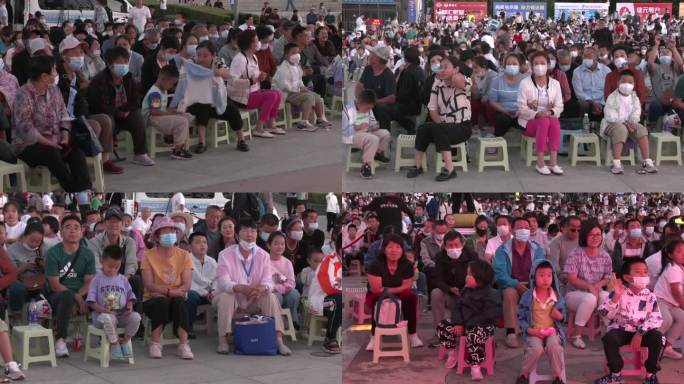 演出前广场上坐满了观众老人小孩