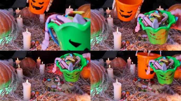 在万圣节的背景下，一桶桶的糖果燃烧着蜡烛和传统的南瓜，孩子们收集糖果并分享糖果