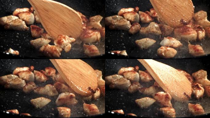 在煎锅里翻炒鸡肉。用高速摄像机拍摄，每秒1000帧。