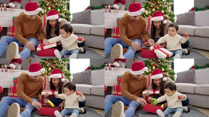 一对夫妇和儿子坐在家里圣诞树旁的地板上拆礼物