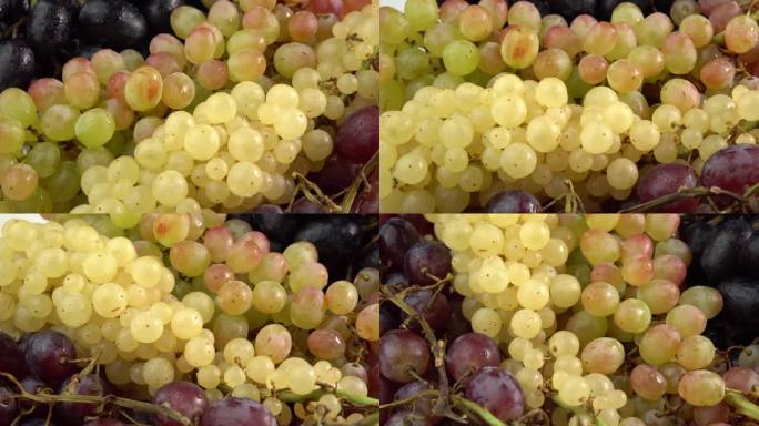 不同品种的新鲜葡萄串作为背景旋转。葡萄特写，概念酿酒，葡萄酒生产，葡萄品种