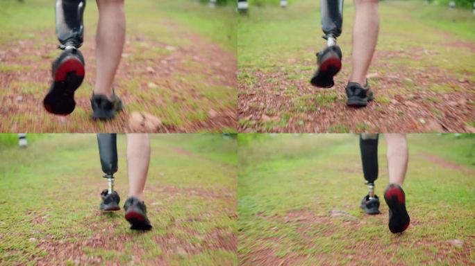 亚洲残障男子假腿行走在森林附近长满草的土路上的特写，中年男性利用闲暇时间在户外散步锻炼，以获得积极情