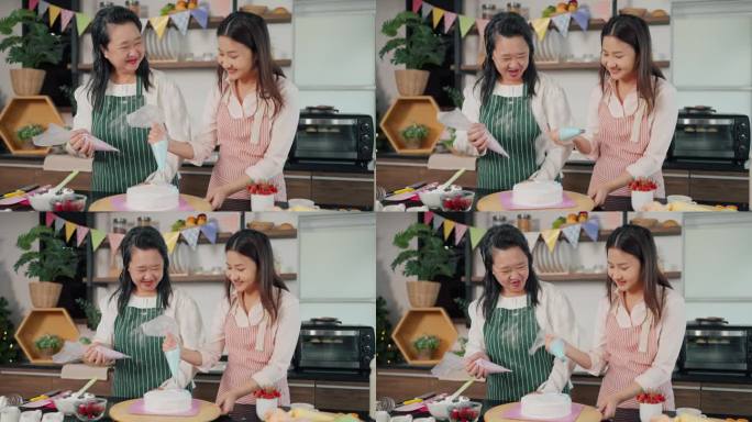 快乐的亚洲老母亲和小女儿一起帮忙把奶油挤到蛋糕上。自制糕点，烹饪蛋糕。家庭与烹饪理念