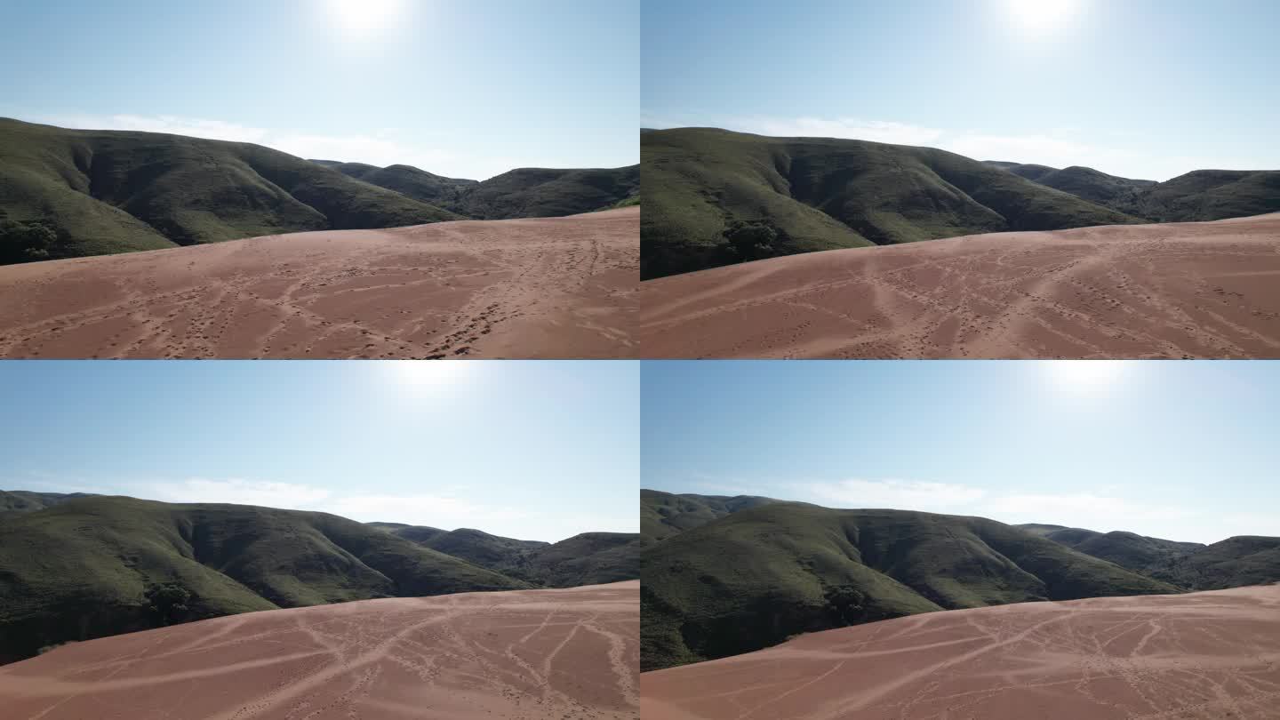无人机在沙丘上撤退，在贫瘠干燥的土地上留下脚印