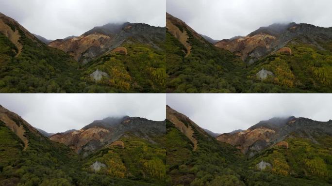 阿拉斯加一座山的鸟瞰图，露出了不同的岩石层和五颜六色的火山岩、碳酸盐岩和千层岩