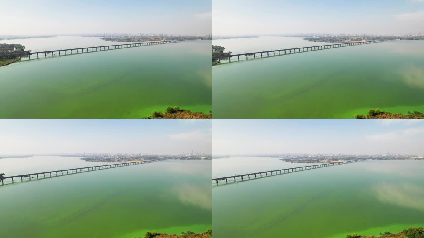 中国江苏省苏州，无人机在阳澄湖上空飞行。阳光明媚的秋日，苏州美丽的湖景和铁路桥全景鸟瞰图，4k实时画