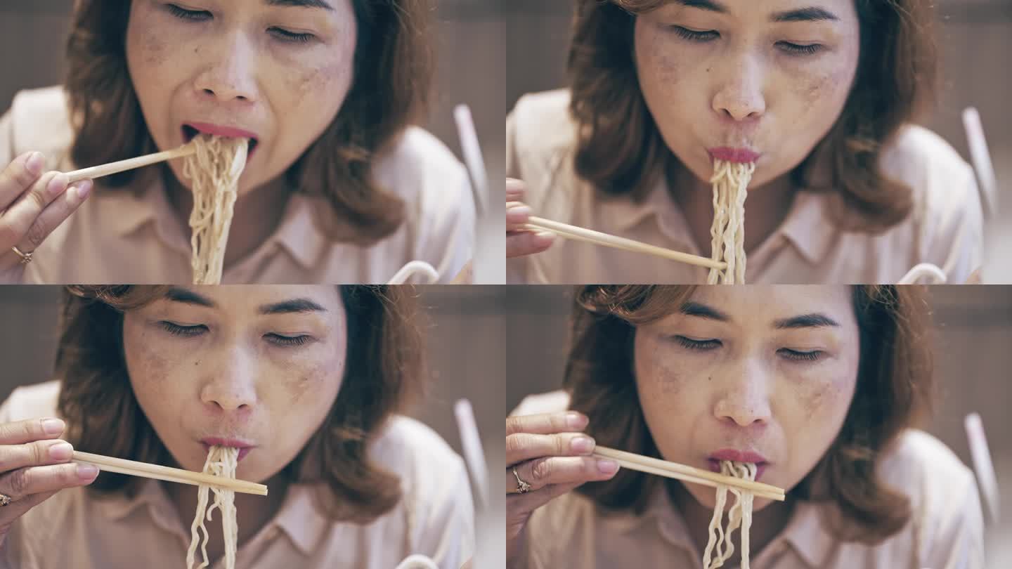 女人在吃拉面、日本汤面。