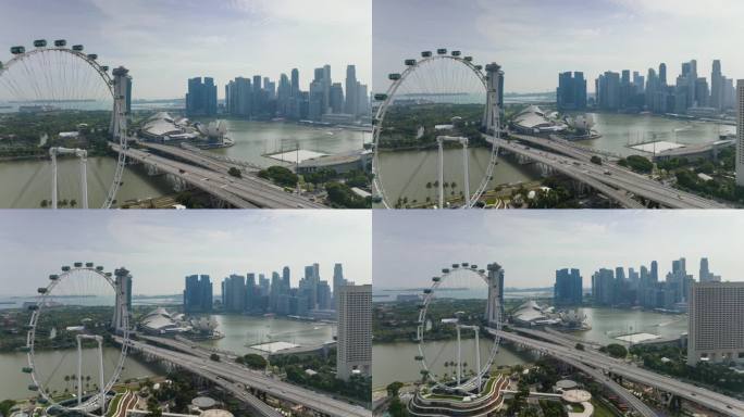 阳光明媚的一天，新加坡市中心滨海湾摩天轮观赏交通大桥航拍全景4k延时拍摄