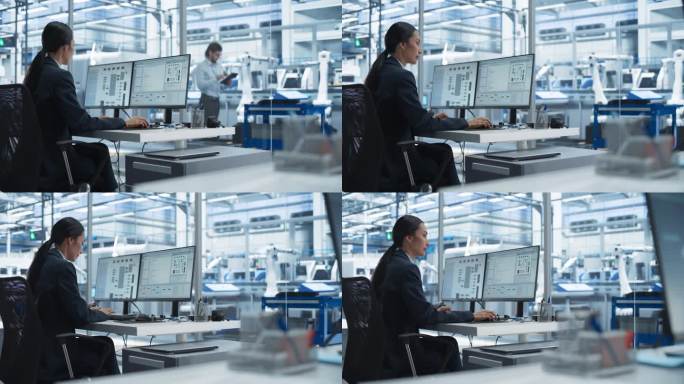 亚洲软件开发人员在台式电脑上管理云计算神经系统。在现代技术设施中工作的女性，拥有机械臂的自动化生产线