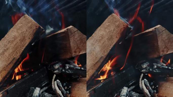 烤架上燃烧的柴火。在烧烤架上燃烧的煤。垂直视频