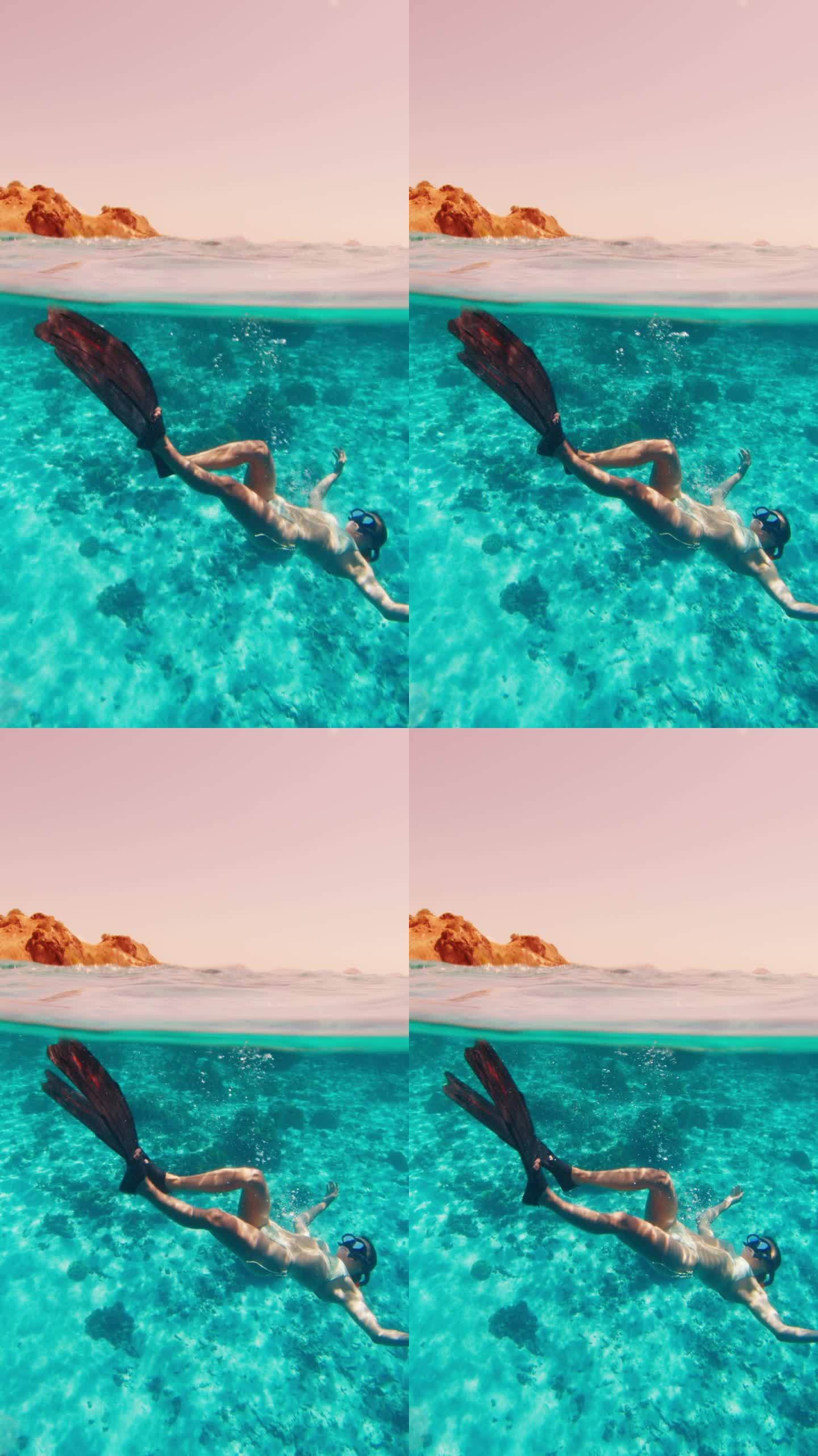 这个女人在热带海水中水下游泳的电影胶片。冻结的海面框架和移动的水下模型
