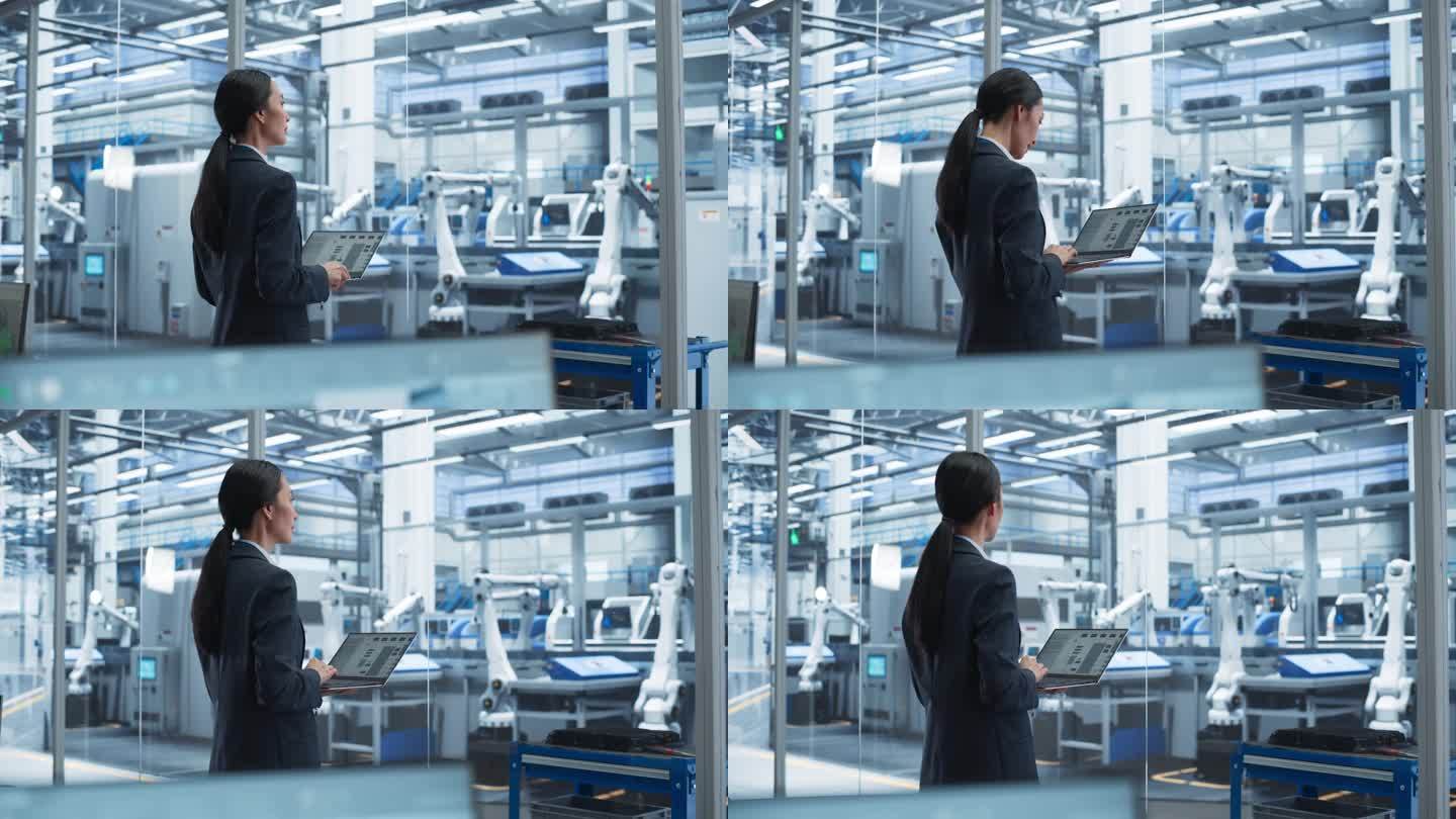 电子制造技术人员在工厂空间里操作笔记本电脑。亚洲女性专家为机器生产和装配开发，维护，微调程序