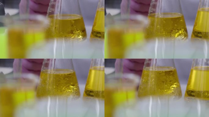 科学家化学家在实验室用机油将液体倒入烧瓶中，特写4k电影慢动作