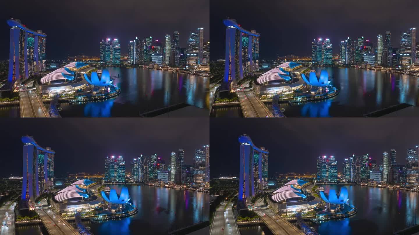 夜间照明飞行在新加坡城市著名的市中心滨海湾航拍全景4k延时
