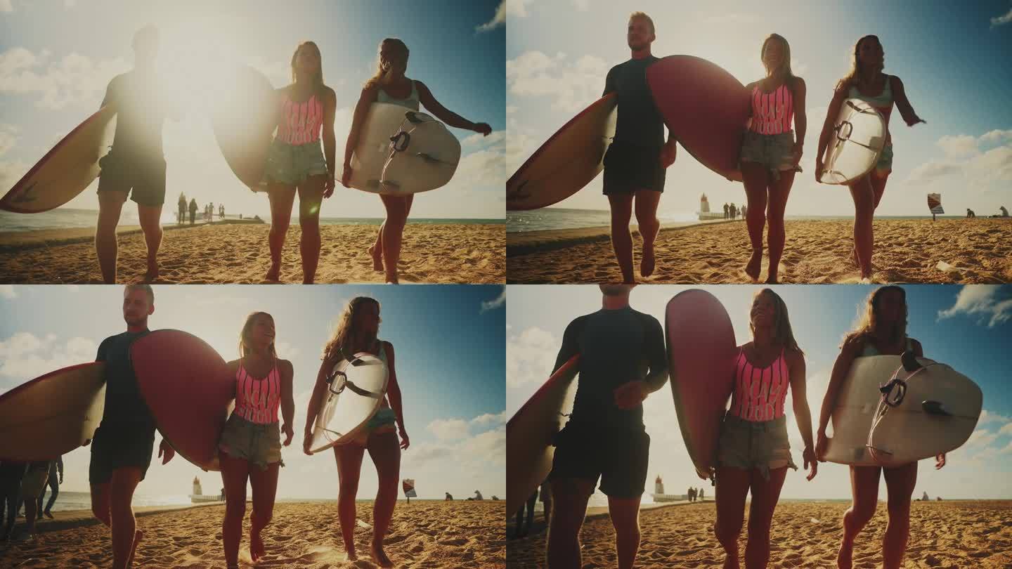 冲浪的朋友们在阳光明媚的夏日沙滩上带着冲浪板散步。享受冲浪假期