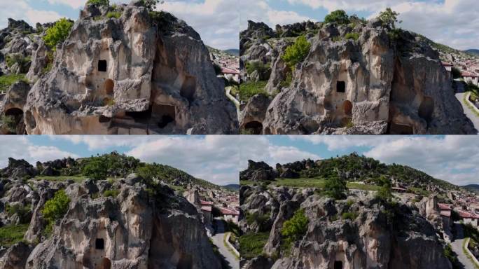 无人机攀爬到阿菲永卡拉希萨尔村和山边的古老的阿亚兹尼岩屋