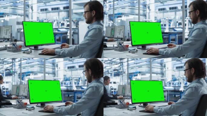 在工厂办公室里，机器人工程师在一台带有绿屏Chromakey模拟显示器的台式电脑上工作。具有自动装配