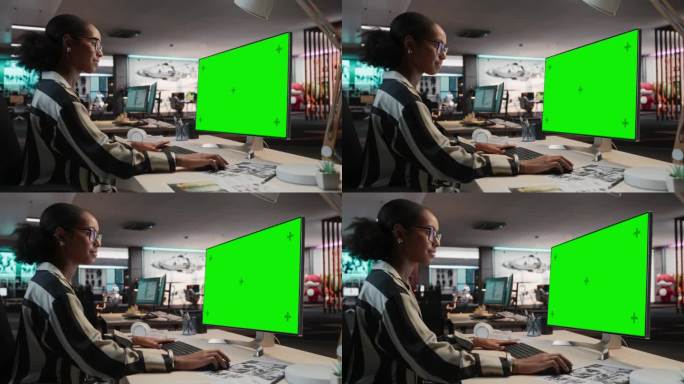创意黑人女性使用桌面电脑与模拟绿屏Chromakey。在游戏设计初创公司工作的女性概念美术师，为新的