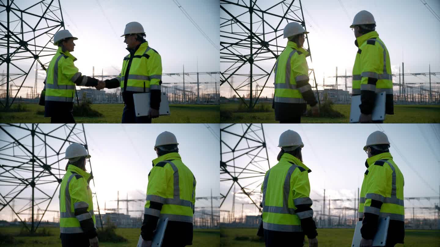 SLO MO自信的电气工程师在日落时分握手并看着变压器