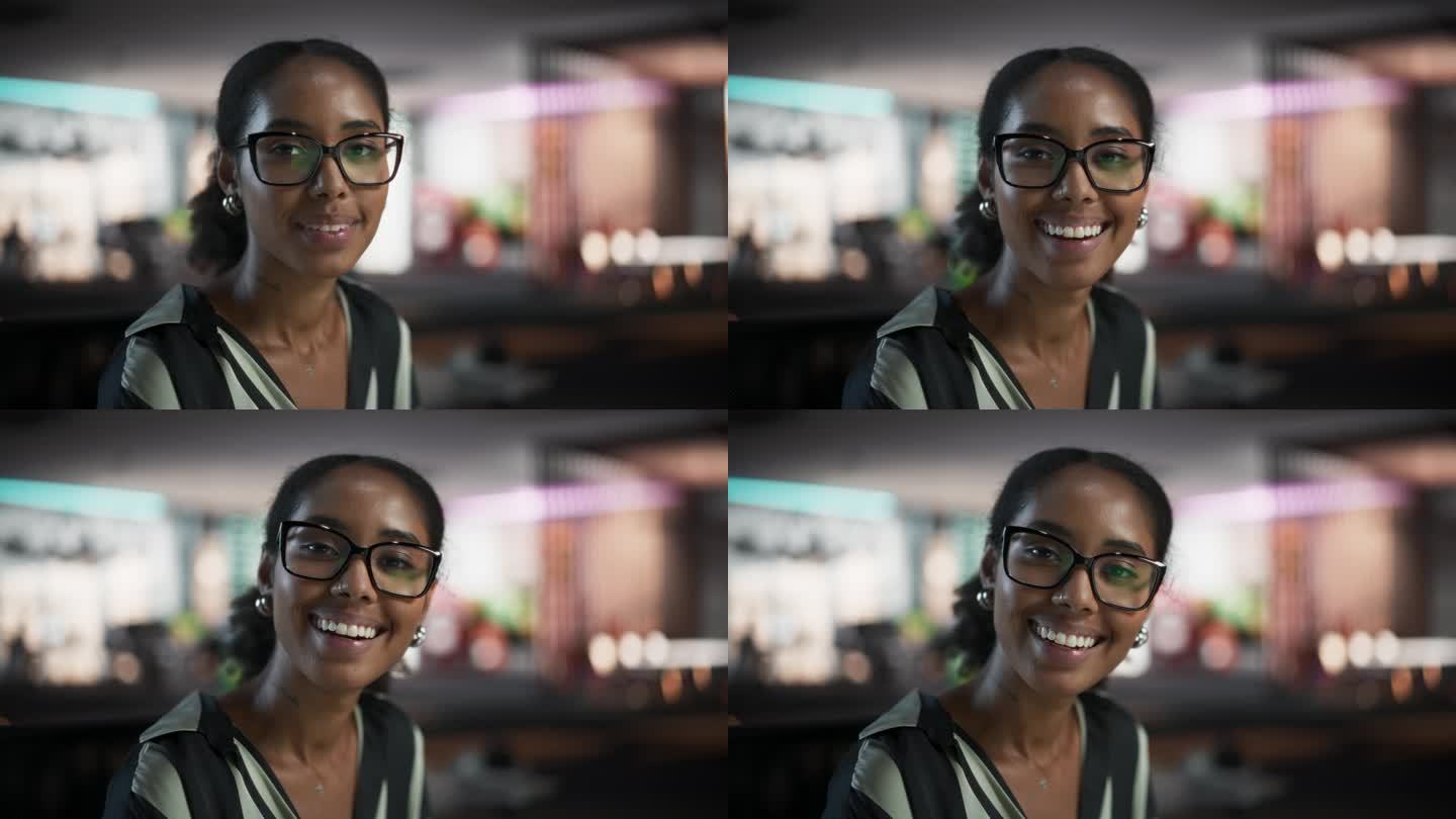 成功的黑人女商人使用台式电脑，分析数据，思考和解决问题的特写肖像。创意公司现代办公室里微笑着看镜头的