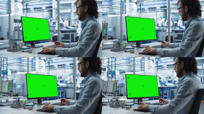 在一家初创工厂，机器人工程师在一台带有绿屏Chromakey模拟显示屏的台式电脑上工作。拥有自主流水