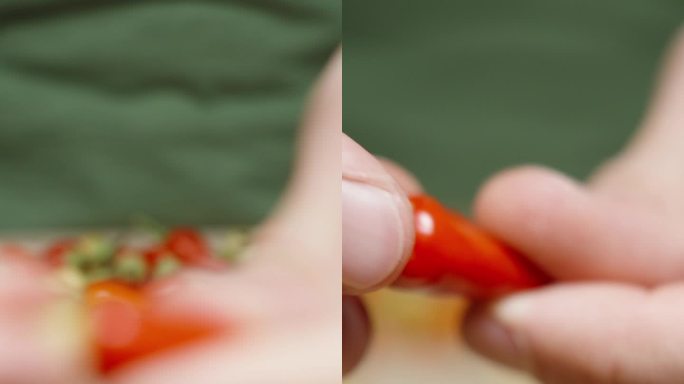 垂直视频。我把迷你红辣椒靠近相机，它慢慢聚焦在它身上。然后，我折断了茎。